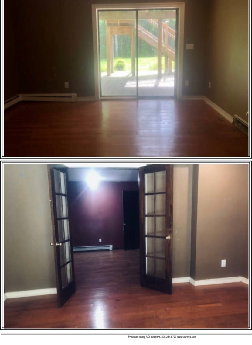 Basement before renovation — dark walls, dark wood floors, French doors