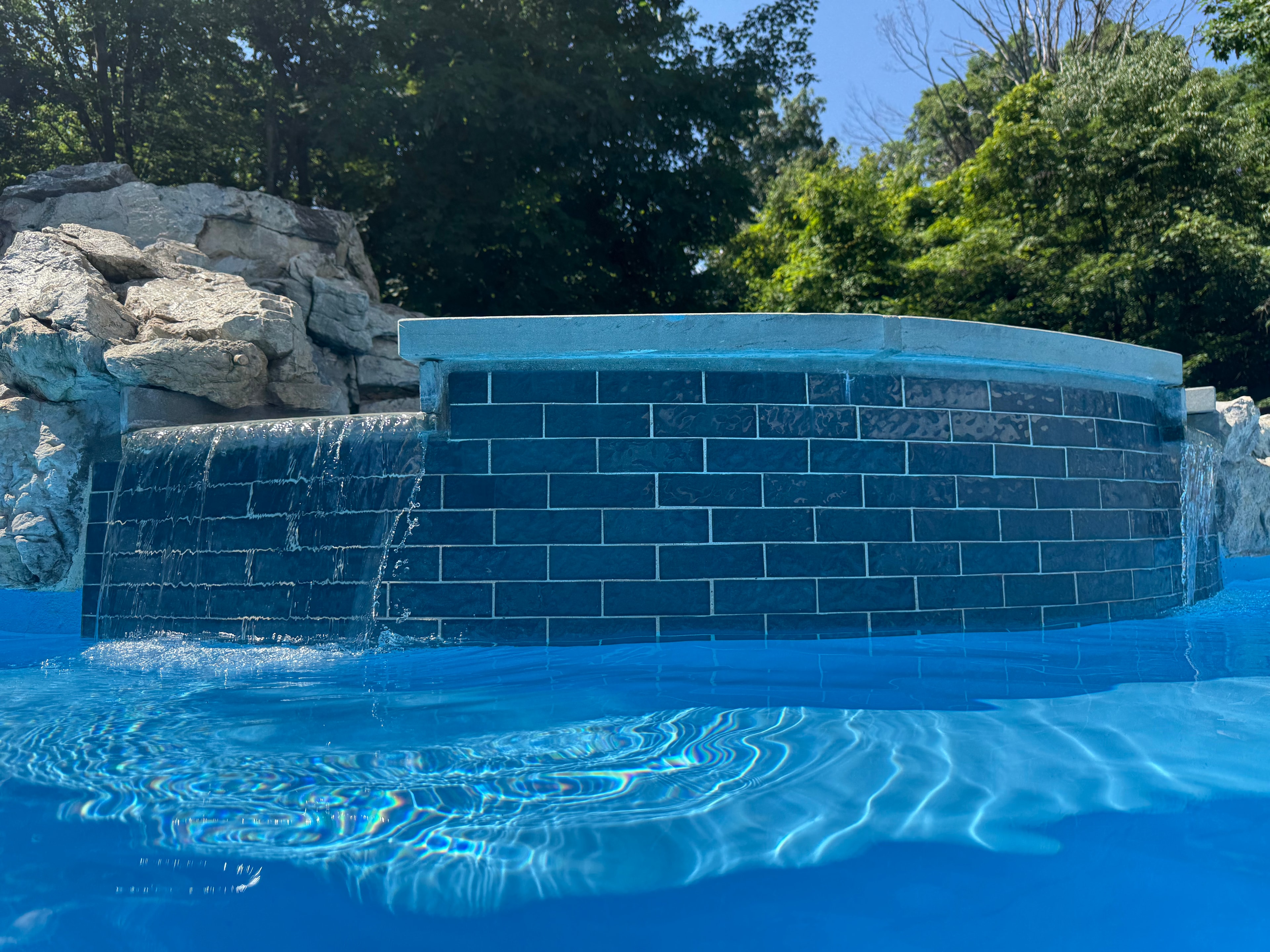 Blue tile waterfall feature close-up after renovation